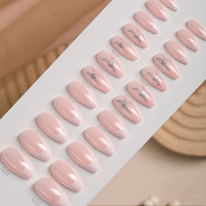 Artificial nail set with delicate pearlescent and glitter accents Stornfield
