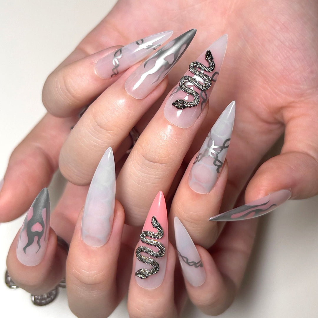 Artistic stiletto nails with snake motif Stornfield