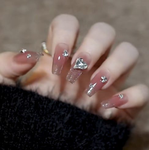 Artistic Nail Art with Glitter and Flower Applications Stornfield