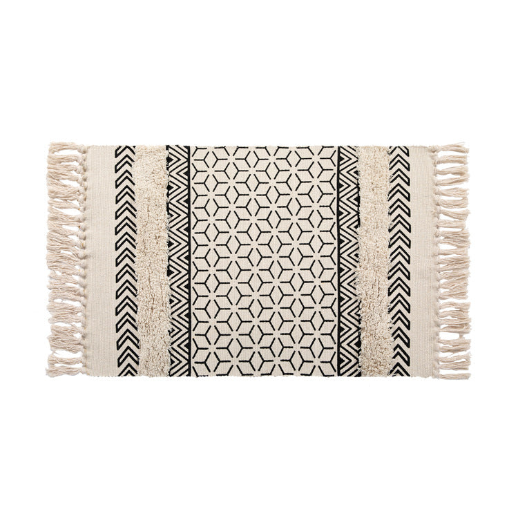 Flat Boho runner rug made of cotton blend fabric with geometric hexagon tufting and decorative fringed edge.