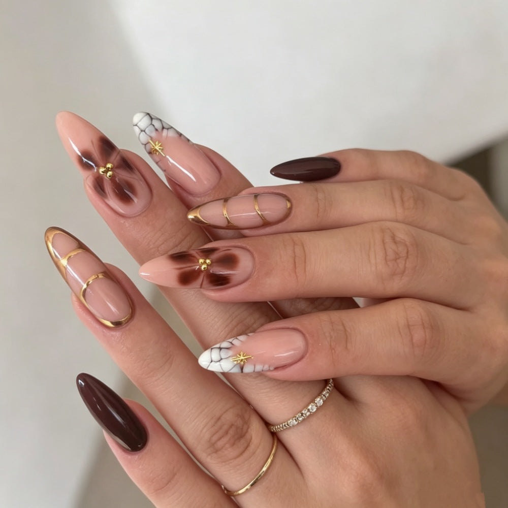 Artificial nails with elegant marble pattern and delicate accents Stornfield