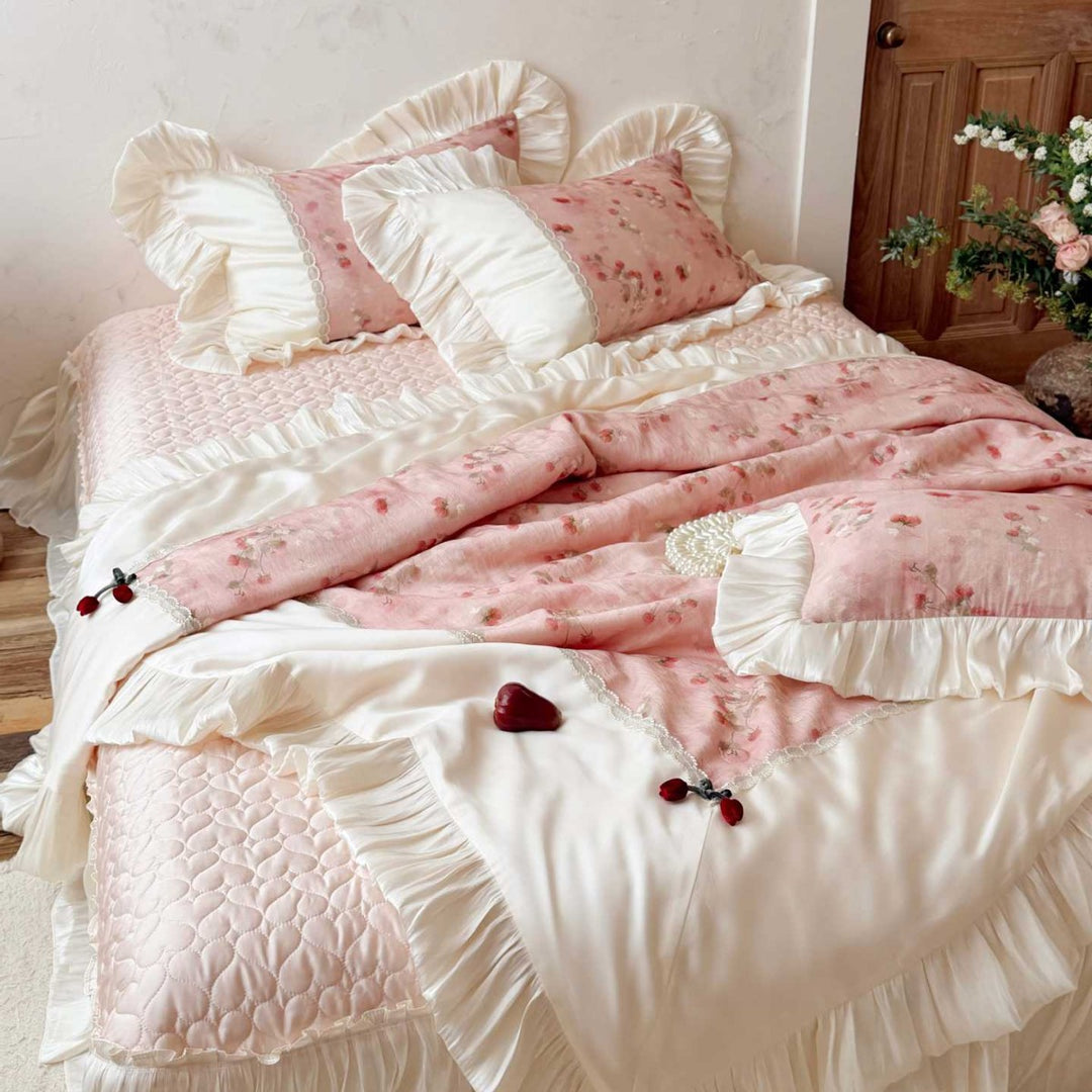 Romantic bedding set with ruffles, quilted bedspread, and decorative pillowcases