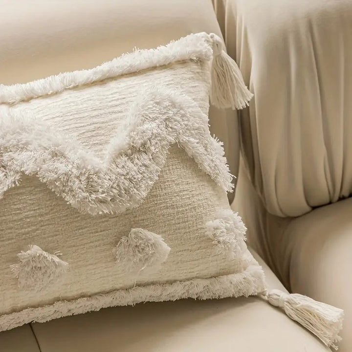 Rectangular decorative cushion cover with hand-tufted chevron and pompom relief as well as corner tassels Stornfield