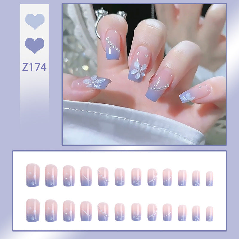 Nail set with elegant floral accents and glitter embellishments Stornfield
