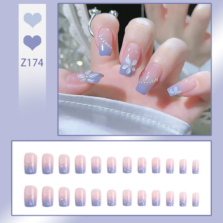 Nail set with elegant floral accents and glitter embellishments Stornfield