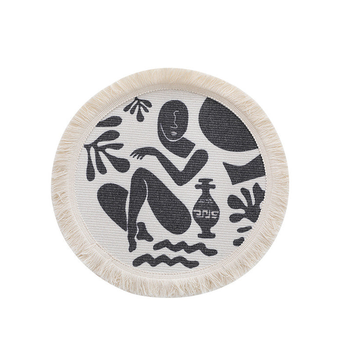 Round woven placemat with fringes and abstract figure motif Stornfield