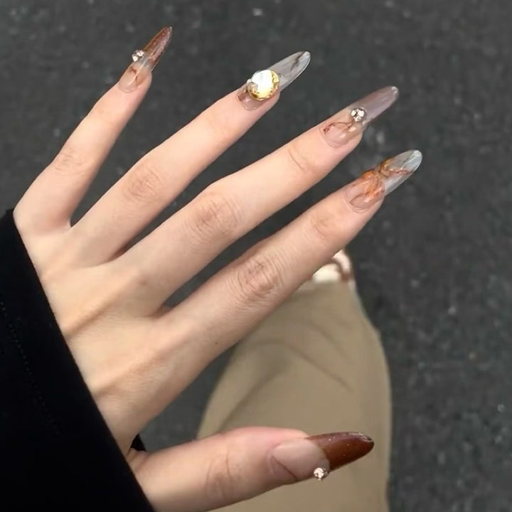 Glamorous artificial nails with creative embellishments Stornfield