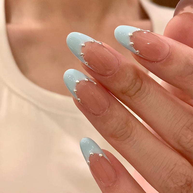 Artistic French Tip Nail Design with Glitter Accents Stornfield