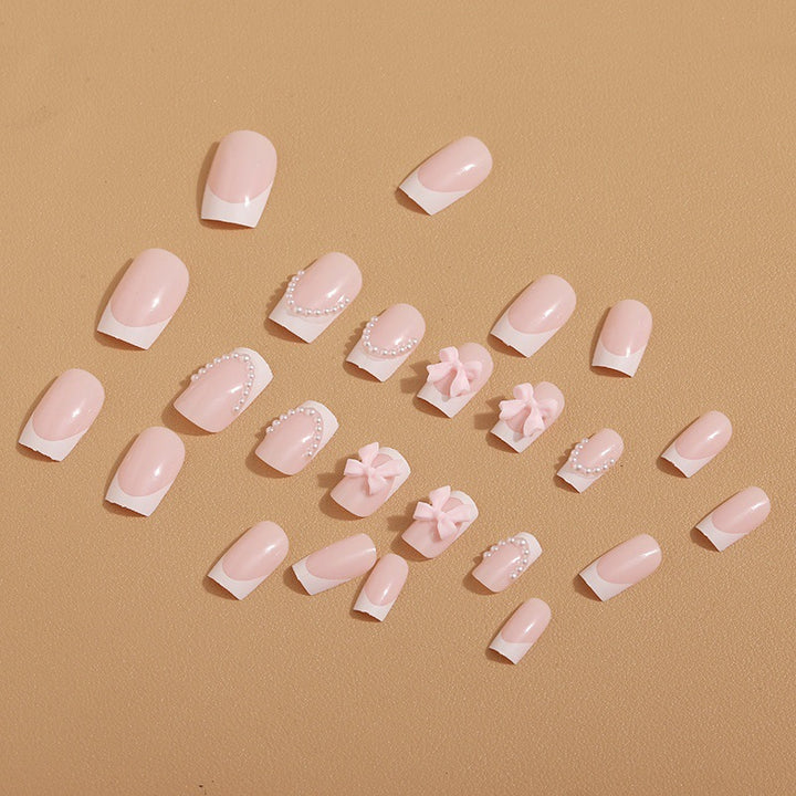 Artificial nail tips with elegant bows and pearl decorations Stornfield