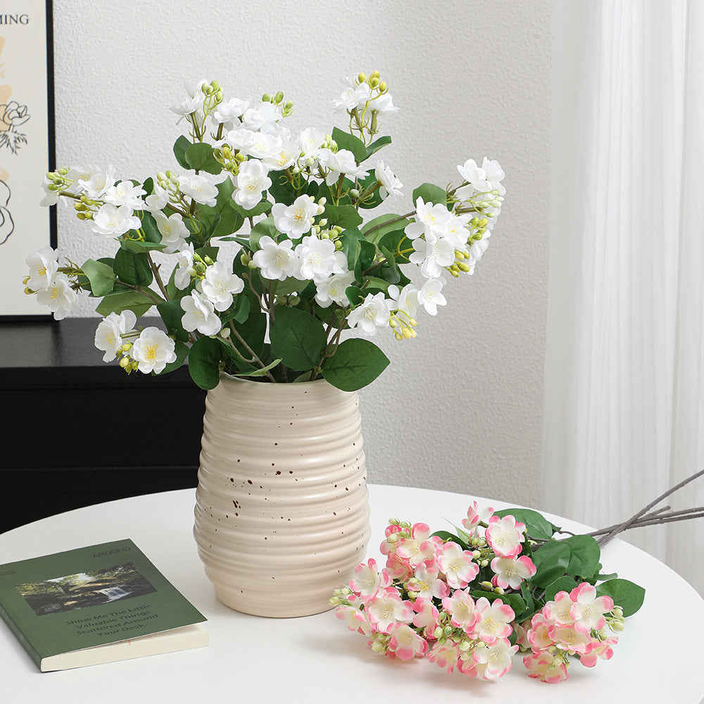 Artificial flower branch with vibrant pink flowers