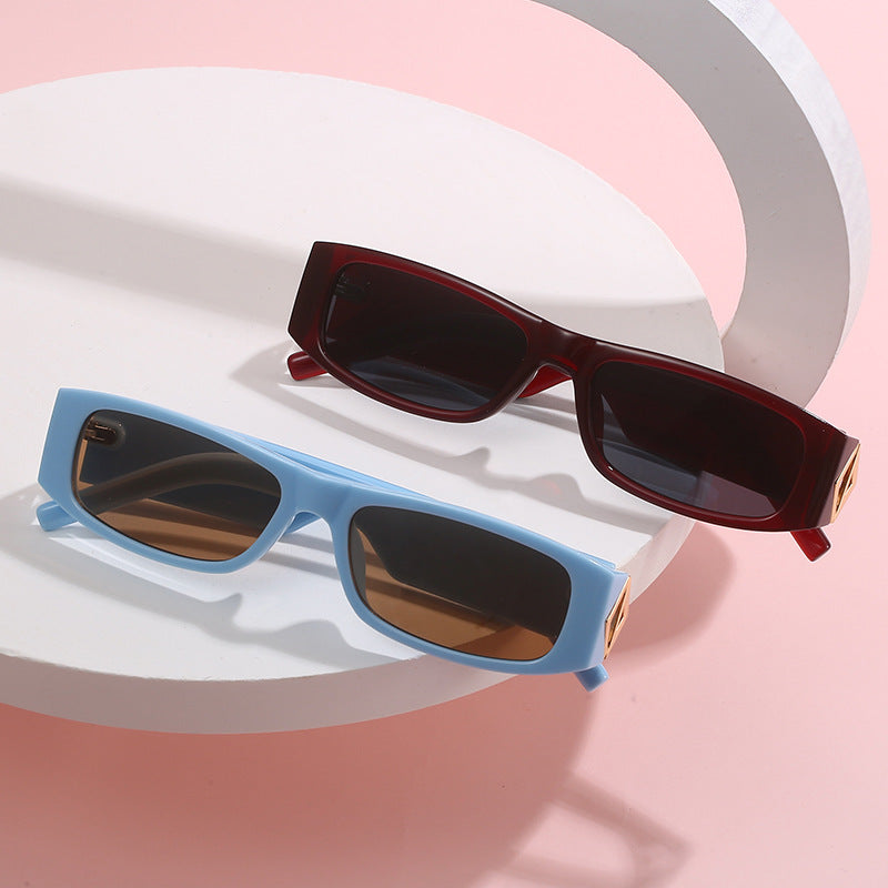 Ladies fashionable sunglasses with asymmetrical frame and gold-colored details Stornfield