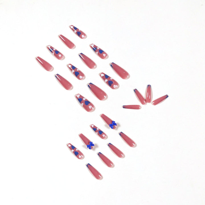 Artful stiletto nails with modern heart and bow motifs Stornfield