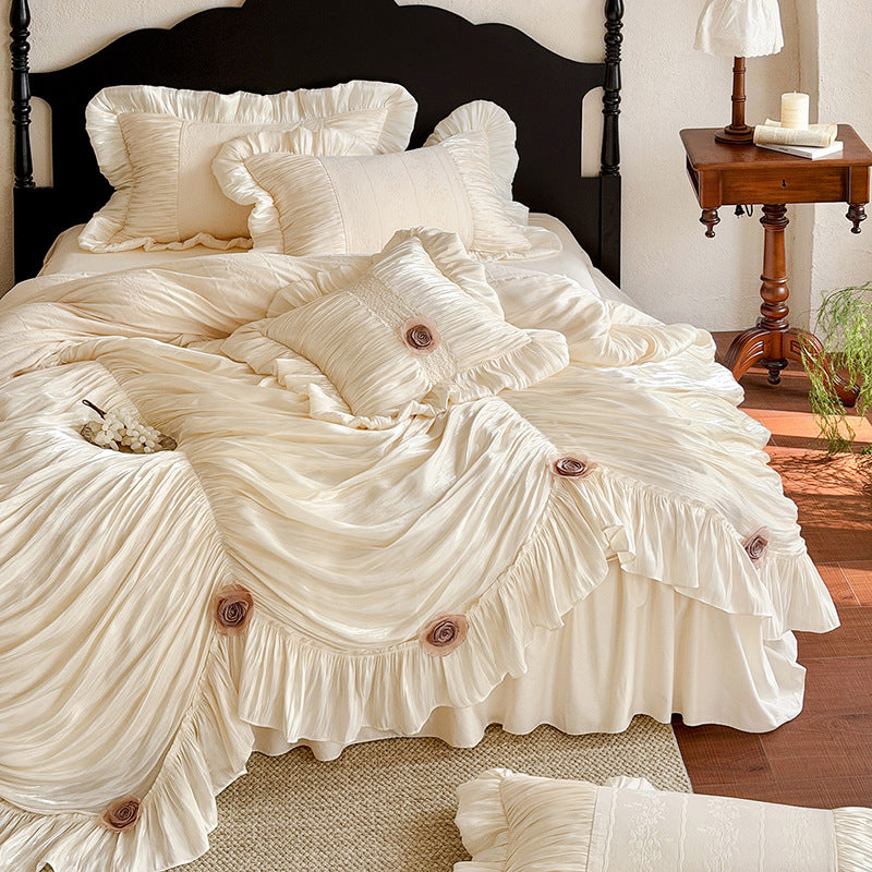 Romantic bedspread set with gathered satin look, frill, and rose appliqués