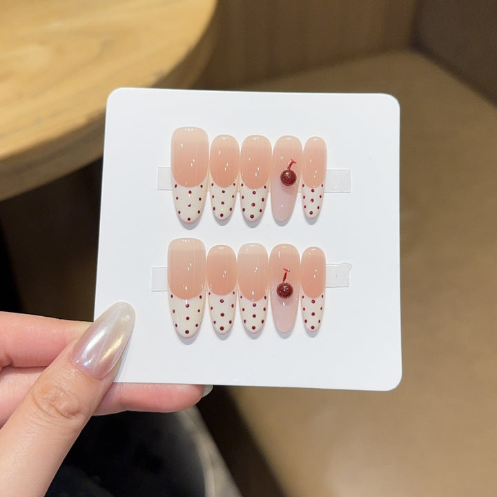 Artificial nails with playful design and cherry accents Stornfield