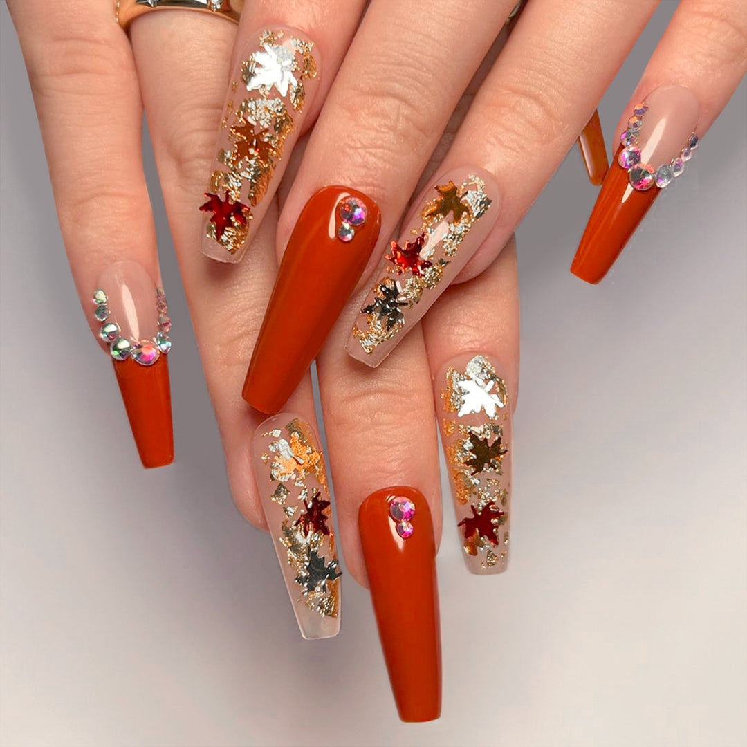 Glamorous acrylic nails with leaf design and glitter accents Stornfield