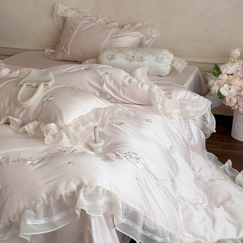 Satin bedding set with fine ruffle trim, delicate floral embroidery, and decorative pillowcases