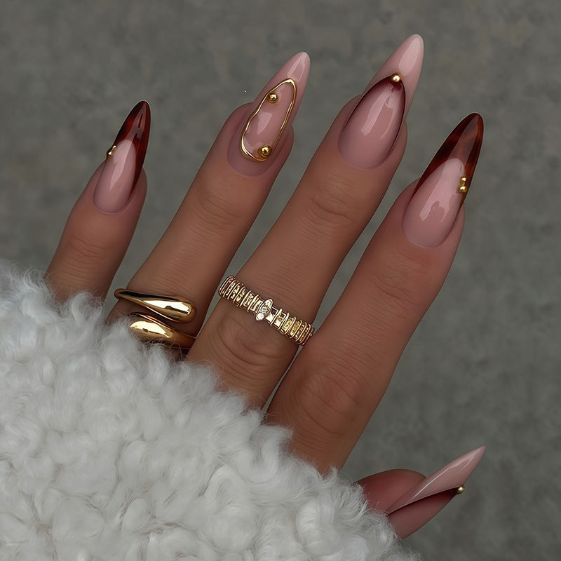Acrylic nail set with elegant ombre design and golden accents Stornfield