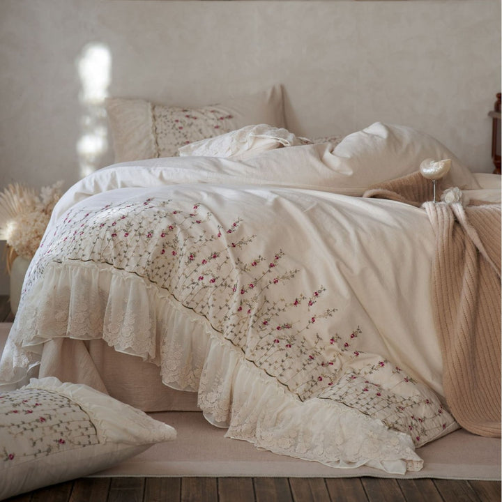 Vintage-inspired ruffled blanket and pillow set made of cotton muslin with delicate floral embroidery
