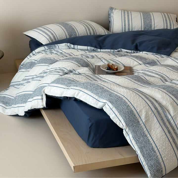 Reversible bedding set with textured striped look and fine quilting