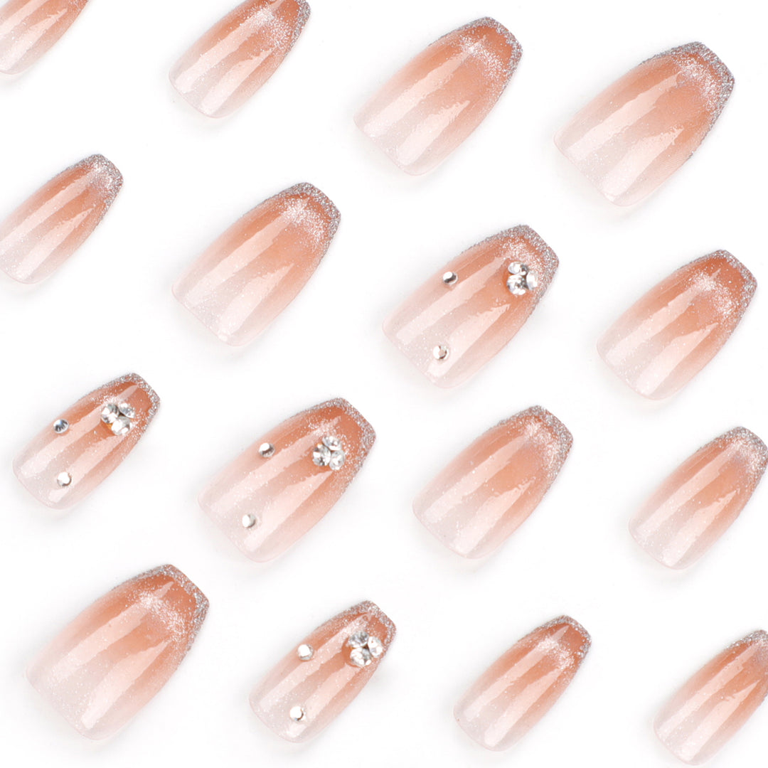 Glamorous artificial nails with glitter and rhinestone accents Stornfield
