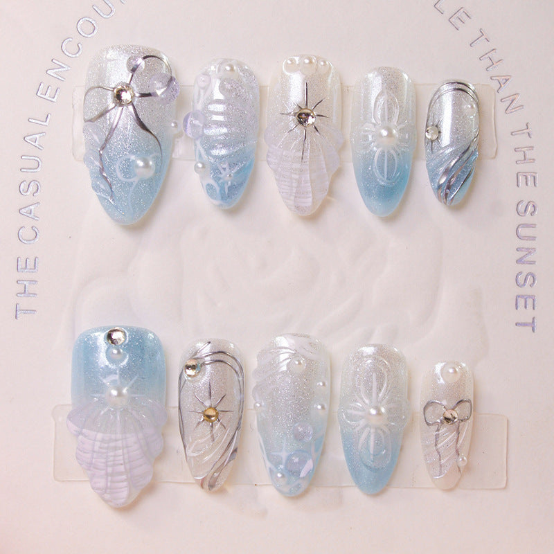Artificial nail set with elegant shell and pearl accents Stornfield