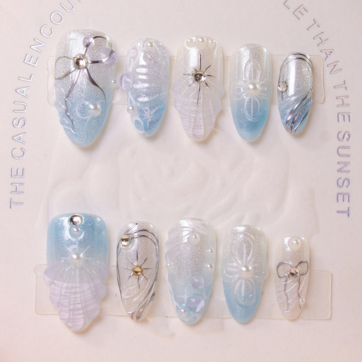 Artificial nail set with elegant shell and pearl accents Stornfield
