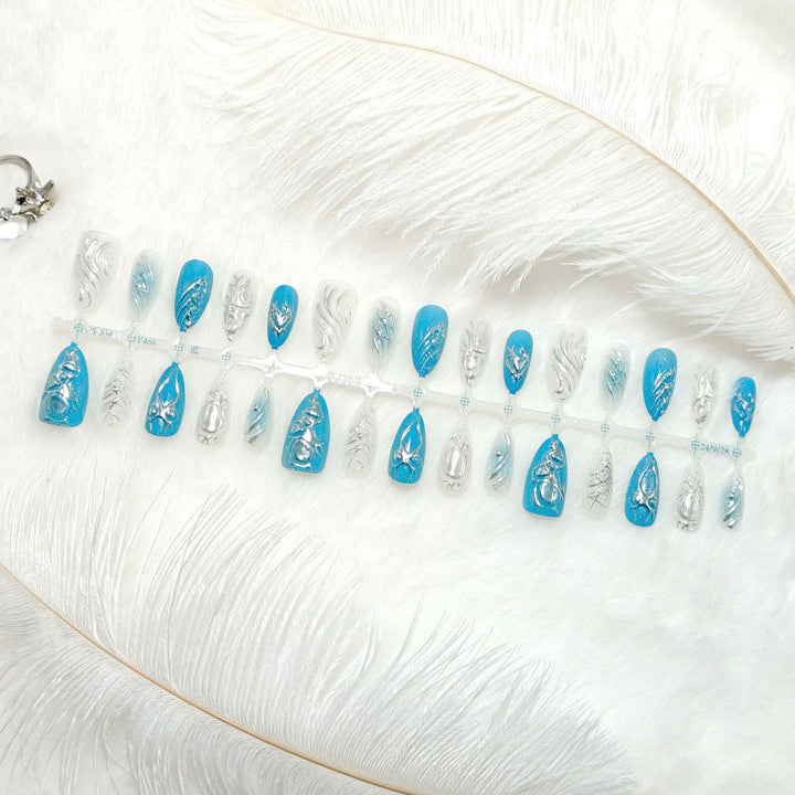 Creative artificial nails with shiny silver and turquoise tones Stornfield