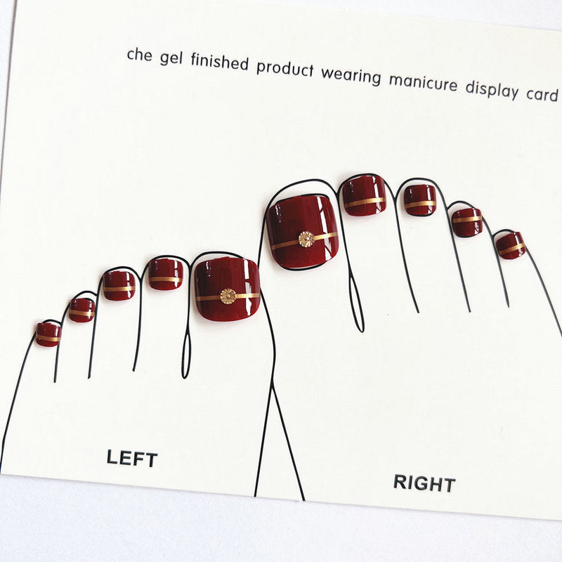 Artificial toenails with elegant gold embellishments Stornfield