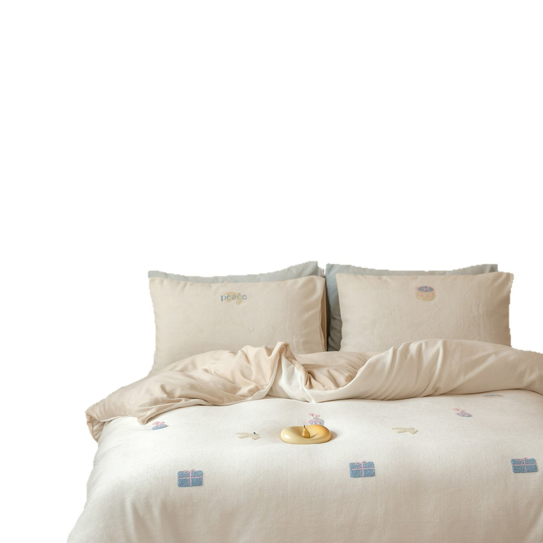 Bedding set with embroidered motif details, pompom trim and soft woven cotton finish