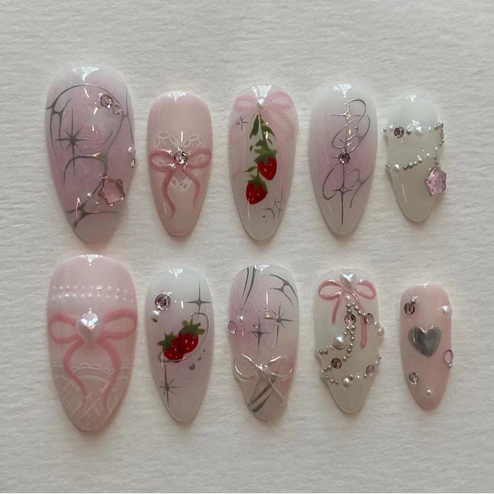 Artificial nail art with romantic design and glitter accents Stornfield