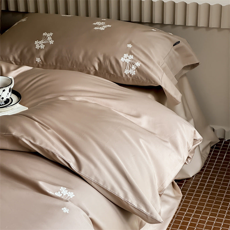 Elegant satin bed linen set with subtle floral embroidery and silk-like sheen