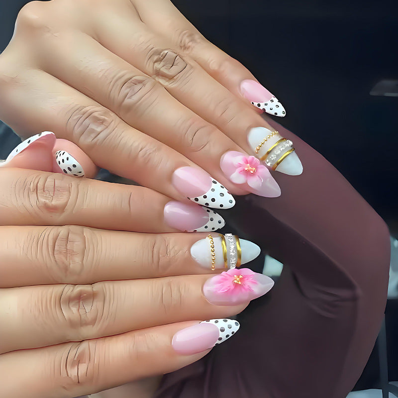Acrylic nail set with romantic floral patterns and elegant glitter decorations Stornfield