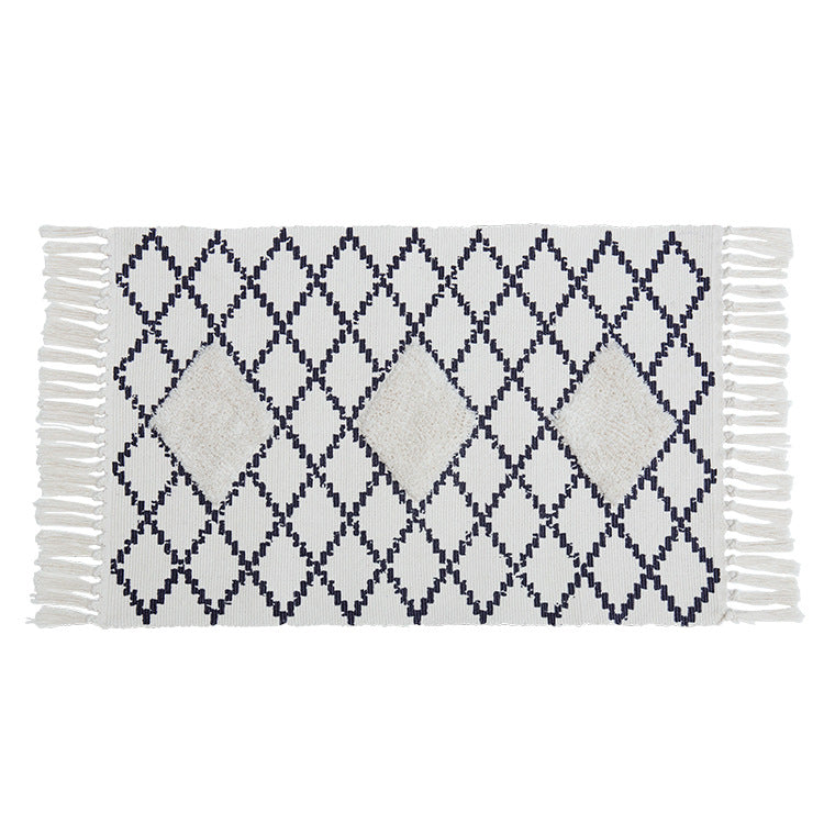 Flat Boho runner rug made of cotton blend fabric with geometric hexagon tufting and decorative fringed edge.