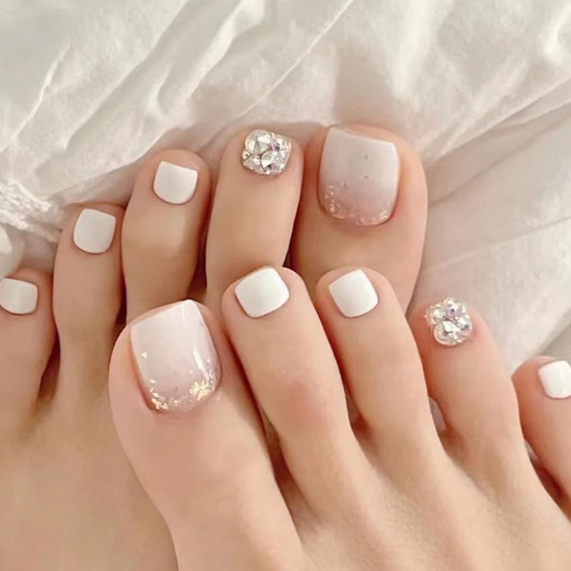 Artful toenail design with sparkling embellishments Stornfield