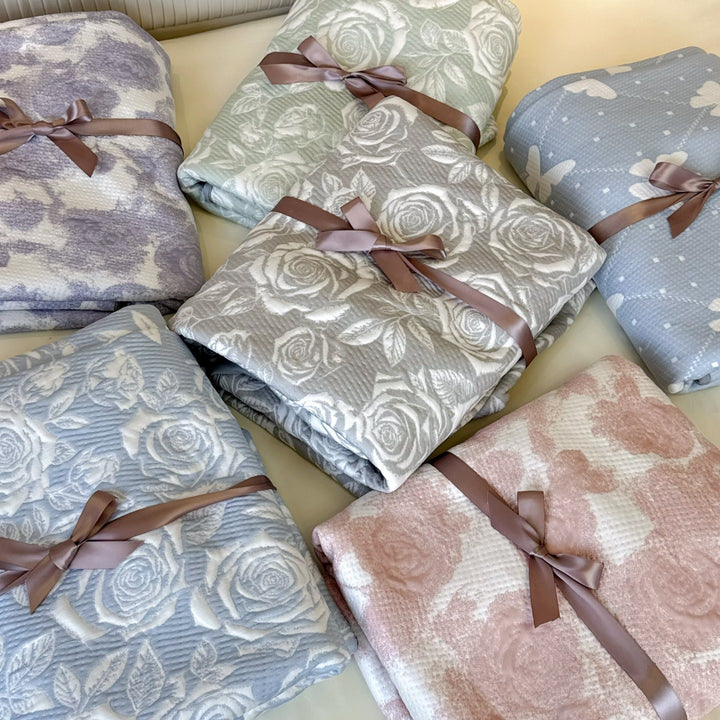 Quilted mattress and pillow set with butterfly motif and pleated bed ruffle