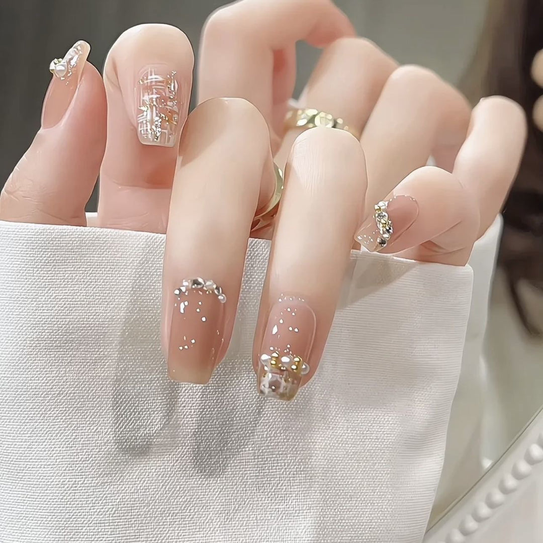 Glamorous artificial nails with striking pearl and glitter elements