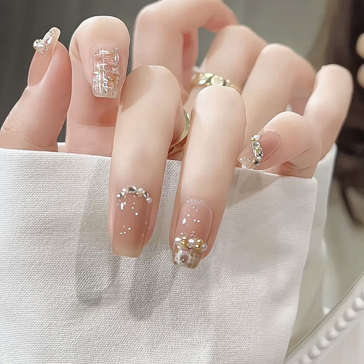 Glamorous artificial nails with striking pearl and glitter elements
