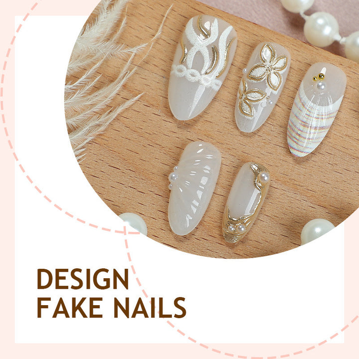 Artificial nail set with luxurious gold embellishments and elegant natural motifs Stornfield