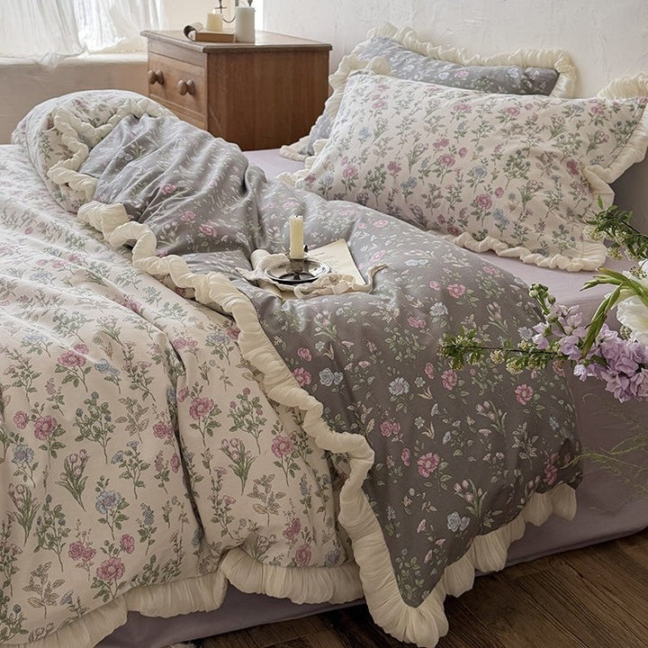 Reversible quilt in vintage botanical design with ruffle and matching pillowcases