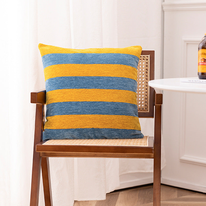 Woven cushion cover with graphic ethnic pattern and contrasting borders