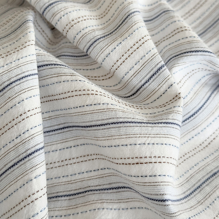 Modern bedding set made of breathable cotton muslin with a fine stripe pattern and reversible function