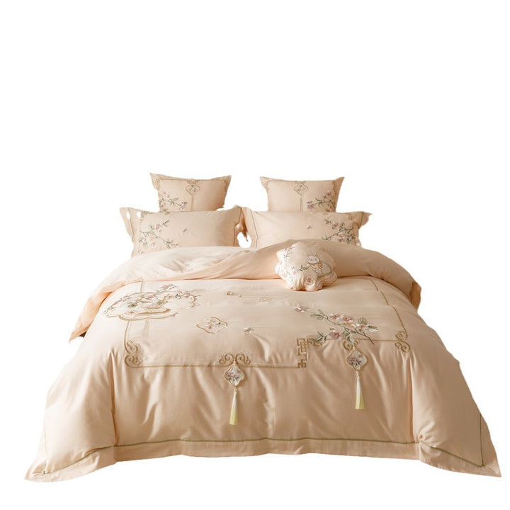Luxurious cotton satin bedding set with fine embroidery, floral motifs, and decorative pillows