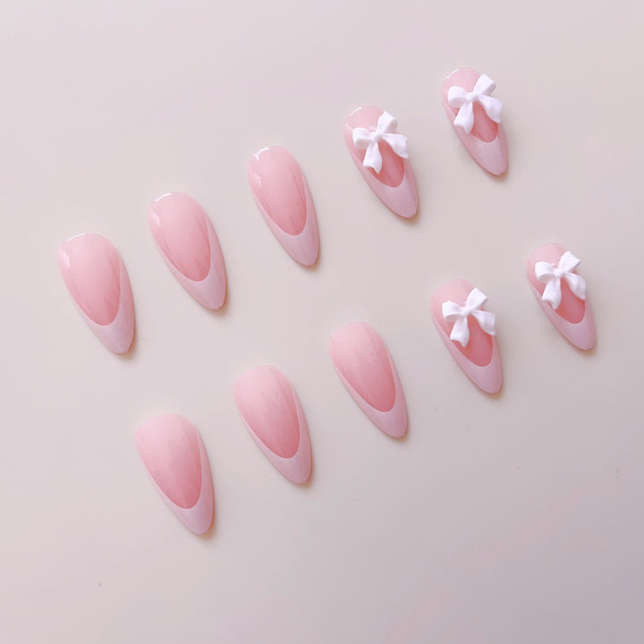 Artificial nail set with elegant tips and delicate bow decorations Stornfield