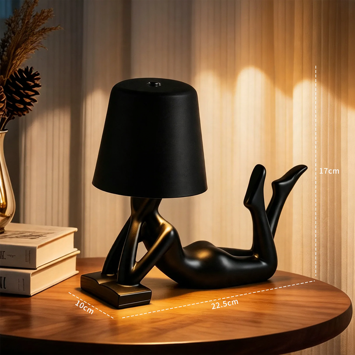 Modern table lamp with reclining figure shape