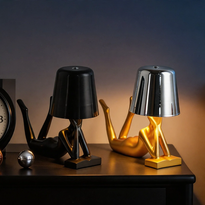 Modern table lamp with reclining figure shape