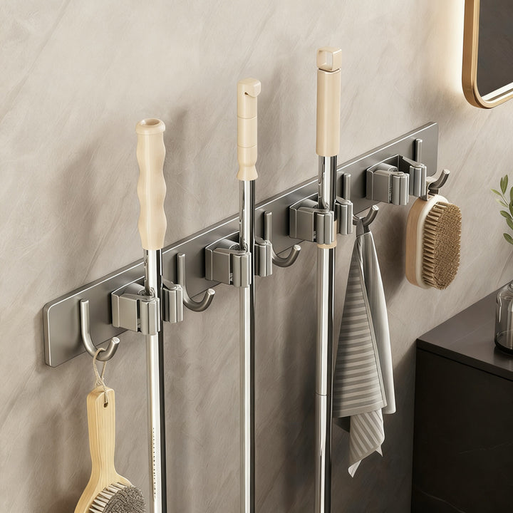 Wall bracket for brooms and mops made of stainless steel
