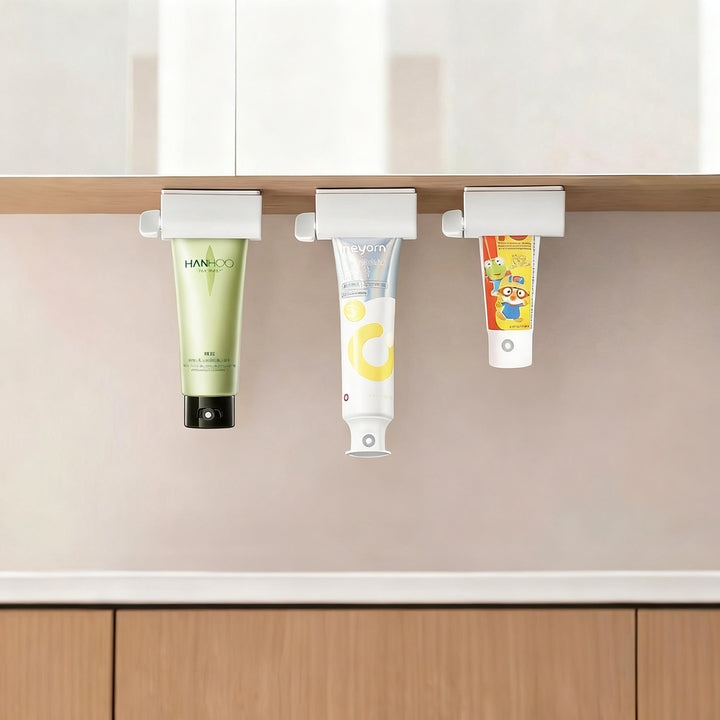 Magnetic toothpaste squeezer with holder